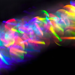 Defocused lights. Multicolor neon lights flares and trails lines in motion on isolated black...