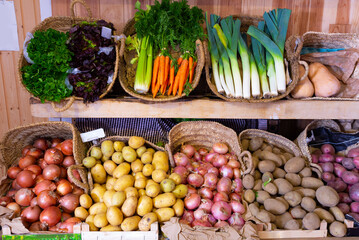 Market counter with large assortment of fresh vegetables for sale. High quality photo