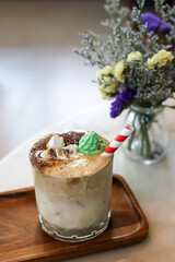 Milky Caramel drink with marshmallows and sugar Santa dolls.