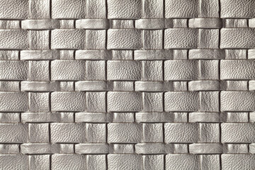 Texture of gray and silver leather background with wicker pattern, macro.