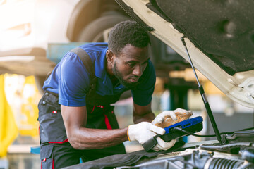 African-American mechanic working in car service center