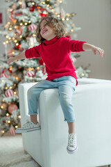 Portrait of a charming boy at Christmas at home. Fashionable child. High quality photo.