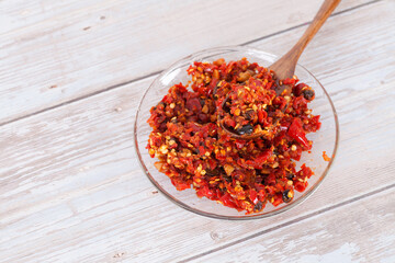 A plate of chili sauce and a wooden spoon inside