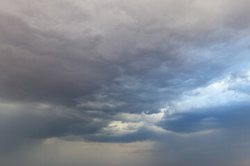 Dark storm clouds in sky before thunderstorm and rain. Dramatic sky background