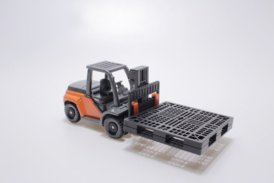 A Scale Of Forklift Truck Isolated On Board