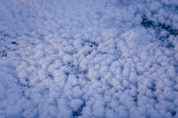 Close up view of ice, snowflakes on the ice in winter