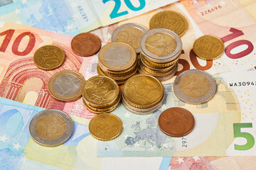Money background. 20, 10 and 5 Euros in paper money and various coins euro cents macro close up 