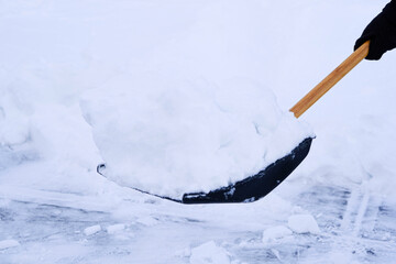 Clearing snow from driveway after heavy winter storm