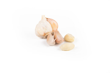 On white background. Head of garlic with cloves next to it. Close-up. No isolation.
