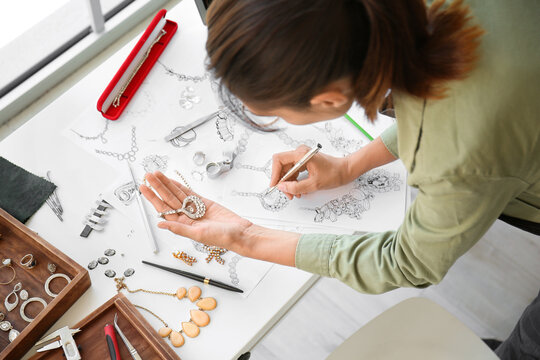 Female jewelry designer working in office