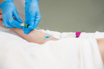 Laboratory worker doctor takes a blood sample for analysis, hand closeup. Blood sampling in the laboratory. Taking a blood in cosmetology clinic before PRP therapy procedure.