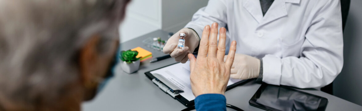 Female Patient Refusing The Coronavirus Vaccine Offered By Her Doctor