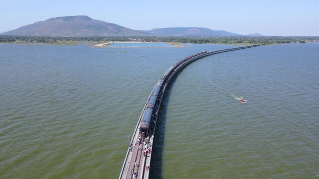 Aerial view point of interest, Thailand Excursion train parked on the floating railway bridge for tourists to take a pictures in the lake of "Pa Sak Jolasid dam" at Lopburi province, amazing Thailand.