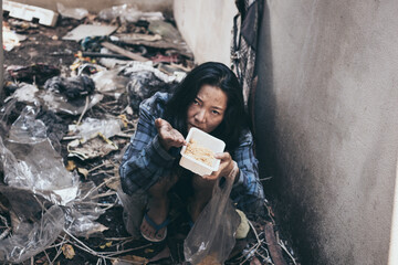 poor people,homeless or beggar begging for help sitting at dirty slum.concept for poverty...
