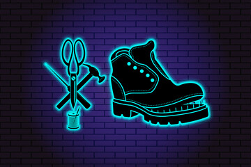 Shoe repair service. Neon symbol in old retro style. On background of brick illuminated wall