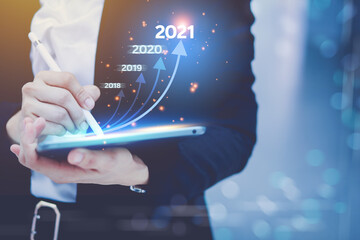 The concept presents a business graph of the technology of annual revenue. From a laptop, a clear overview of the process, a clear average of all organizations for the year 2021.