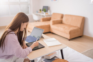 Asian female students studying online at home