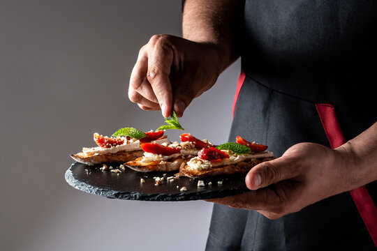 Sweet sandwiches with strawberries, cheese, camembert, brie, nuts and honey on the bruschetta cooking by chef hand. banner menu recipe place for text