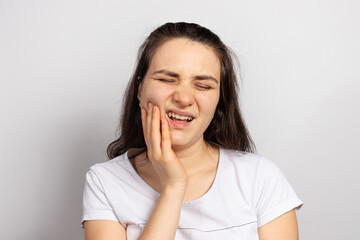 The woman suffers from toothache - tooth decay or pulpitis, inflammation, a filling fell out or a broken tooth ate a hard nut. Toothache, photo for dental clinic and dentist. Oral care