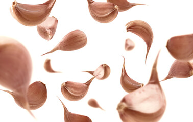 Garlic cloves levitate on a white background