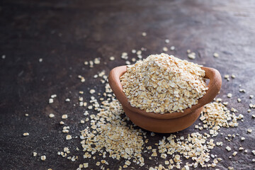 Oatmeal in clay pot with wood background. raw food for healt concept.