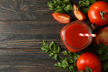 Jar with tomato juice, tomatoes and parsley on wooden background