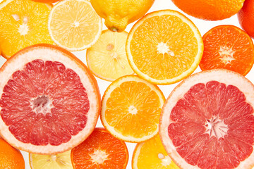 Colorful creative background of orange, lemon, grapefruit and Mandarin slices. Flat lay macro close-up, top view