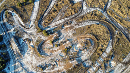 Frozen city road. Winter aerial cityscape of town with road. Splendid morning view from dron.