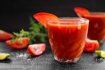 Tomato juice in glass with row tomato on wood background. fresh organic vegetables. healthy juice drinks concept.