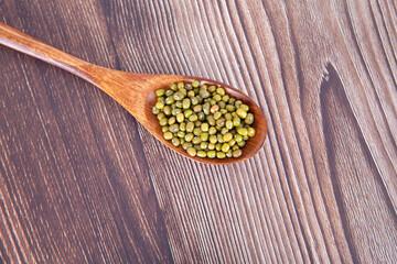 A spoonful of mung beans on the table