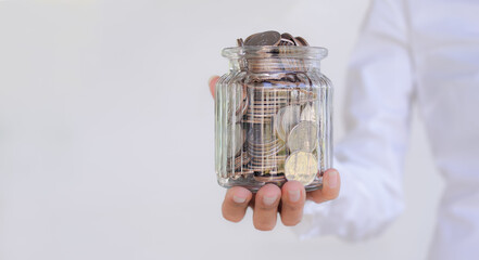 Future plan saving money for 2021 year concept. staff hand woman holding coin in jar on white background.