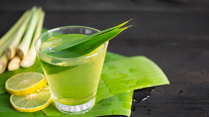 Lemongrass juice in glass on wooden background. Thai herbal drink. for cough remedy, reduce headaches. food for healthcare concept.