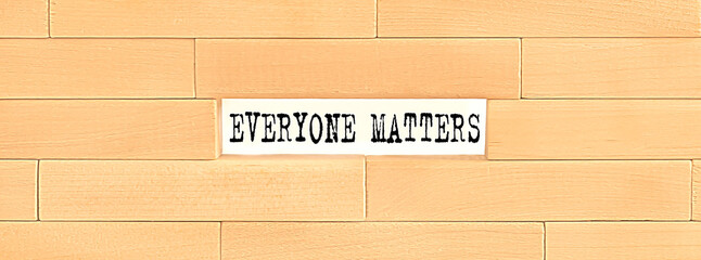 EVERYONE MATTERS text on the wooden block wall, business