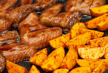 Raw potatoes and chicken wings in soy sauce