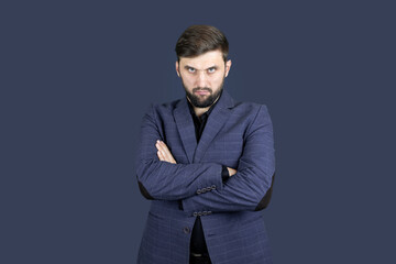 the businessman a man with a beard and a blue suit folded his hands in front of him