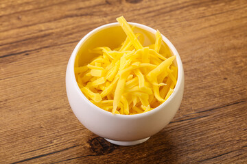 Shredded yellow cheese in the bowl