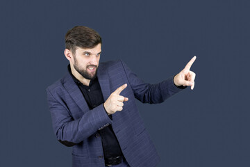 a stylish man with a beard in a blue suit shows the direction with both hands