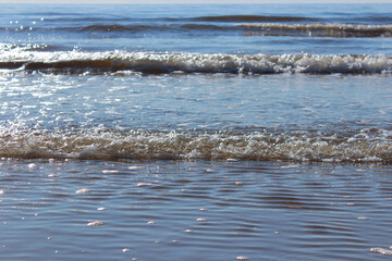 Foamy sea waves rushing towards the coast