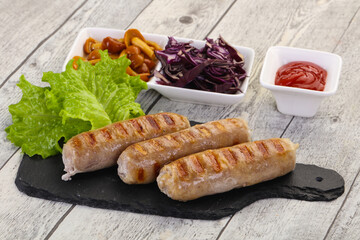 Grilled sausages served mushrooms and cabbage