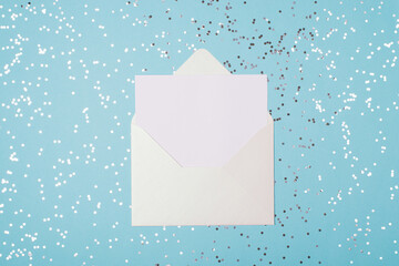 Top above flat lay close up view photo of open white envelope and sheet of paper on light pastel...