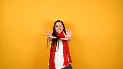 Obraz na płótnie Canvas Girl with a red scarf on a yellow background