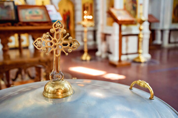 cover of the baptismal font in the Orthodox Church with a handle