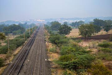 Fototapeta na wymiar Picture of pastel sunset on railroad track in rural scene