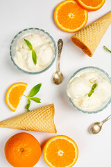 Ice-cream and orange in studio