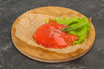 Sliced salmon fillet served rosemary