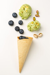 Blueberry, pistachio ice-cream and waffle ice-cream cone 