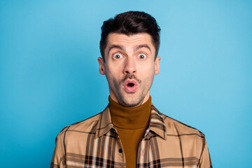 Obraz premium Portrait of young shocked amazed surprised speechless man see shocking unexpected news isolated on blue color background