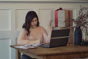 Pretty young lady sitting at desk and typing on laptop with present boxes icons. box receive good online shop purchase at home, post mail shipping delivery concept. woking from home office