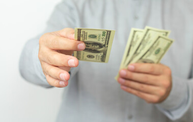 Hands of man proposing money us dollar bills to you