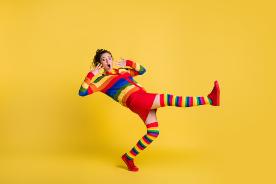 Profile photo of shocked lady felling down slippery floor wear striped sweater short skirt knee socks shoes isolated yellow color background